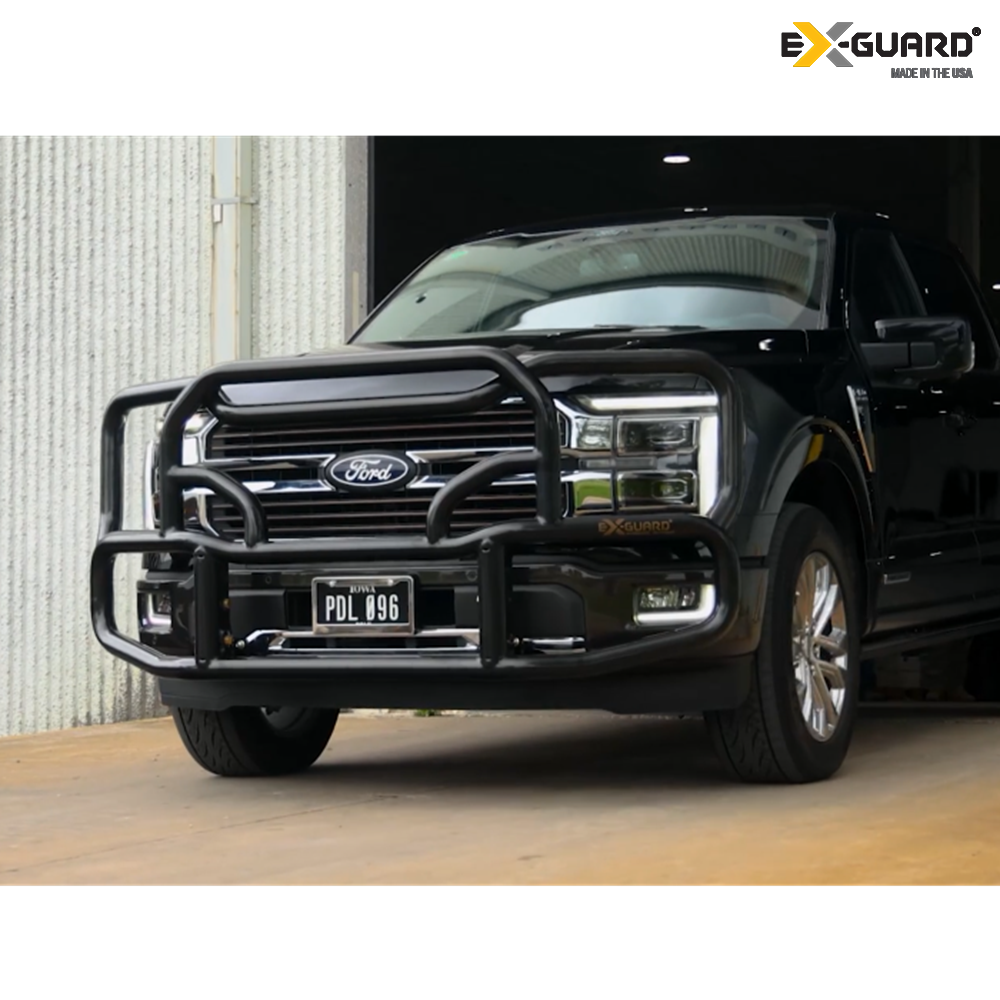 Black Ford F-150 truck with an Ex-Guard Grille Guard bumper guard in a garage setting