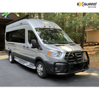 Silver van with roof rack in a wooded area