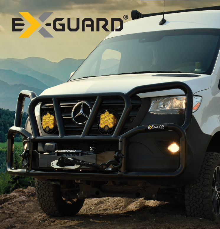 White Mercedes-Benz truck with Ex-Guard Grille guard and winch on a mountainous landscape